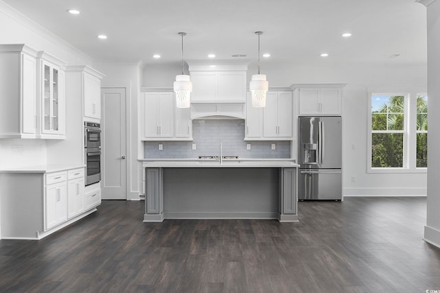 kitchen featuring appliances with stainless steel finishes, light countertops, decorative backsplash, recessed lighting, and ornamental molding