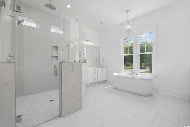 bathroom featuring tile patterned flooring, vanity, independent shower and bath, and an inviting chandelier