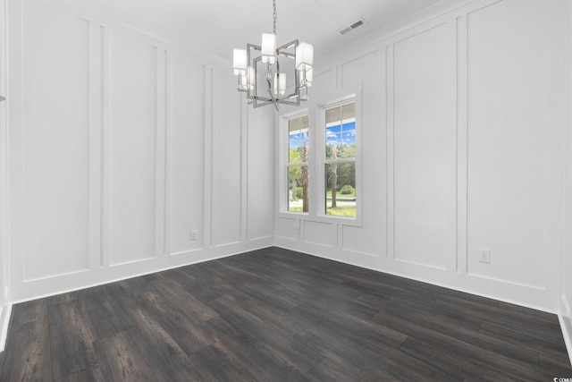 unfurnished dining area featuring dark hardwood / wood-style flooring and a chandelier