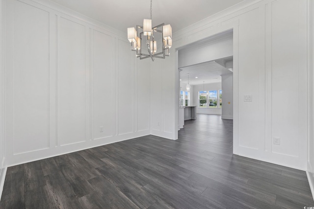 unfurnished dining area featuring a decorative wall, a chandelier, and dark wood finished floors