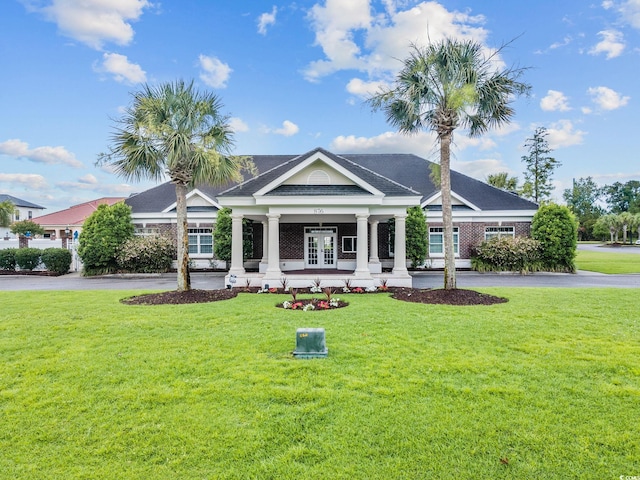 view of front of property with a front yard and covered porch