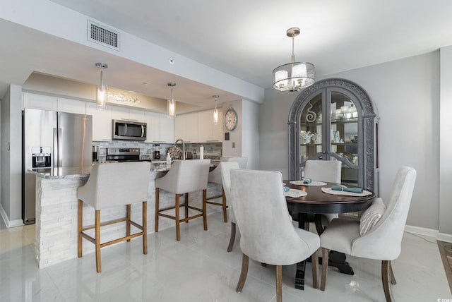 dining room with a notable chandelier and light tile patterned floors