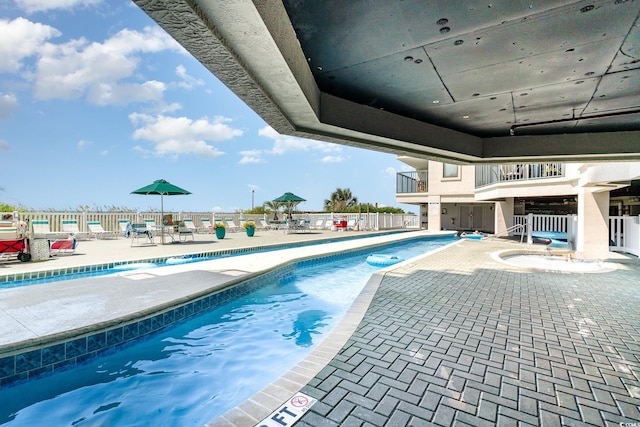 view of swimming pool featuring a patio area