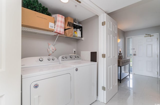 laundry room featuring washing machine and clothes dryer and light tile patterned floors