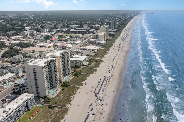 birds eye view of property featuring a water view and a beach view