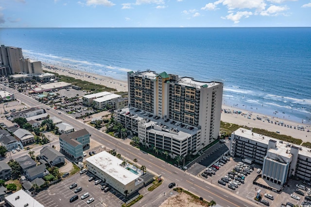 drone / aerial view featuring a water view and a beach view