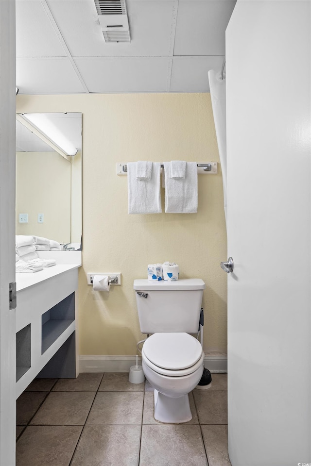 bathroom with vanity, toilet, and tile patterned flooring