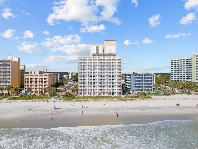 view of property featuring a view of the beach and a water view