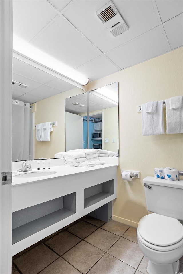 bathroom with vanity, toilet, and tile patterned flooring