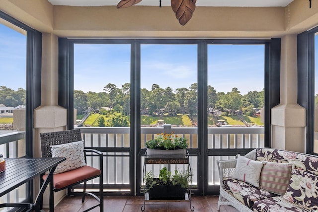 sunroom with ceiling fan and a healthy amount of sunlight