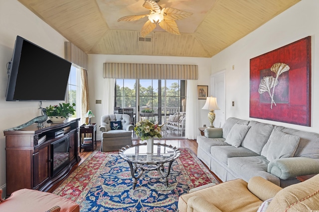 living room featuring ceiling fan, a healthy amount of sunlight, vaulted ceiling, and hardwood / wood-style flooring