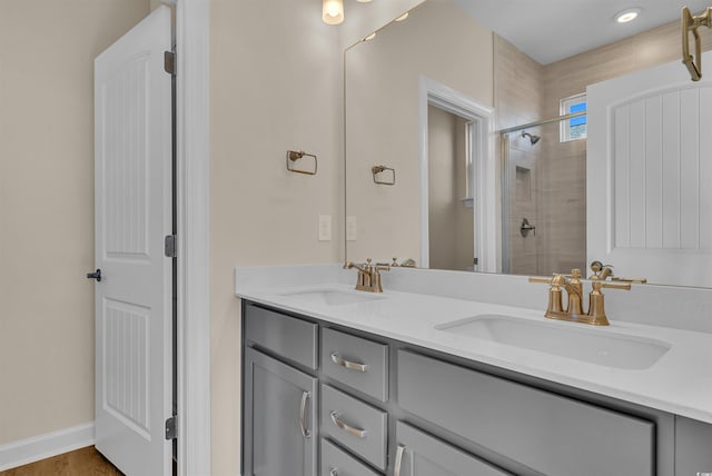 bathroom featuring hardwood / wood-style flooring, vanity, and an enclosed shower