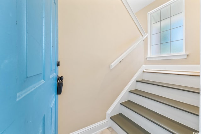 stairway featuring baseboards