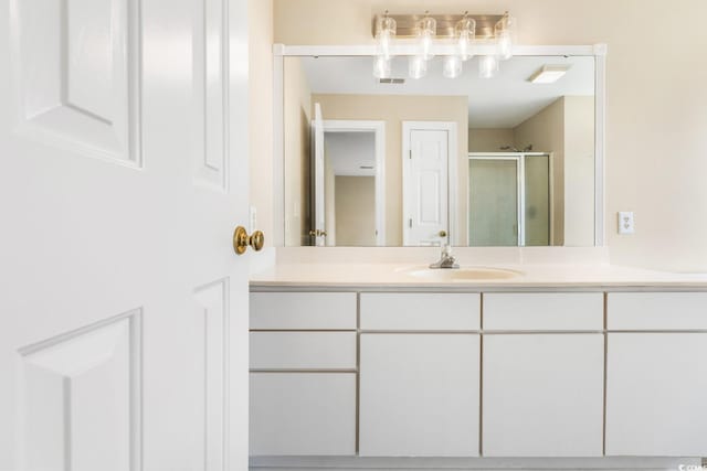 bathroom with vanity and a stall shower
