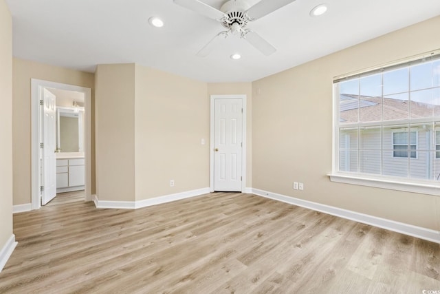 empty room with baseboards, light wood finished floors, and recessed lighting