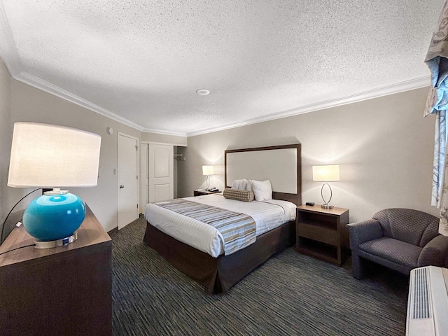 bedroom with crown molding, a textured ceiling, and dark colored carpet