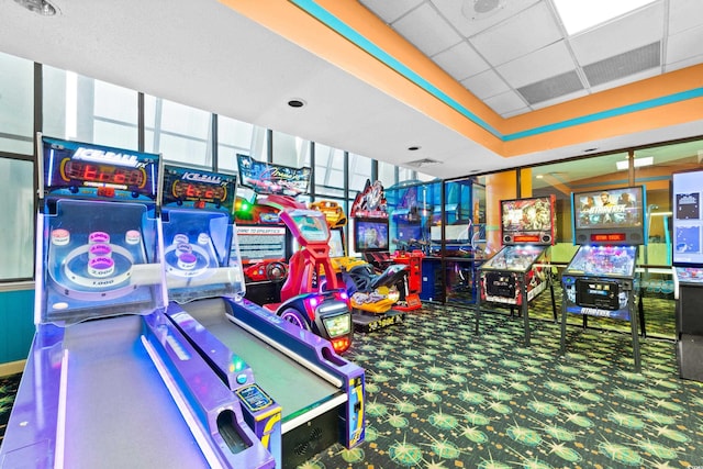 game room featuring a paneled ceiling and carpet