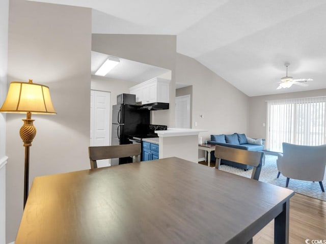 dining room with lofted ceiling, light hardwood / wood-style flooring, and ceiling fan