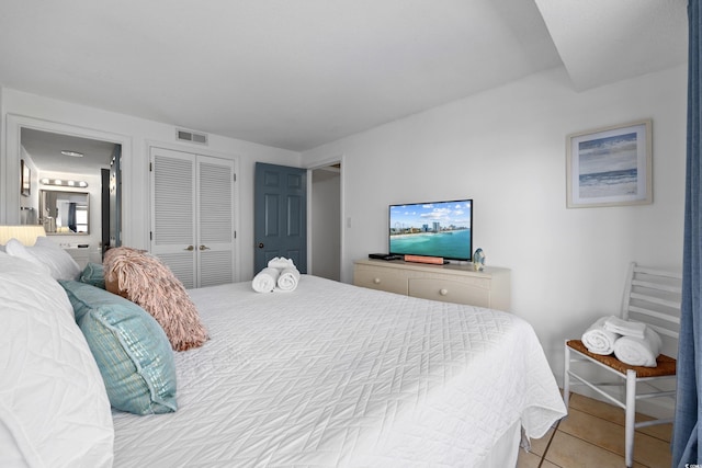 bedroom featuring a closet, visible vents, and light tile patterned floors