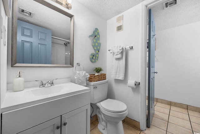 full bath featuring toilet, vanity, visible vents, and tile patterned floors