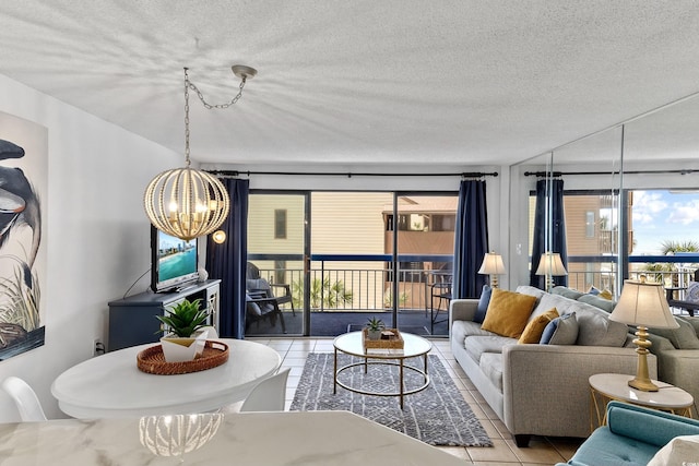 living room with a textured ceiling, an inviting chandelier, and light tile patterned floors