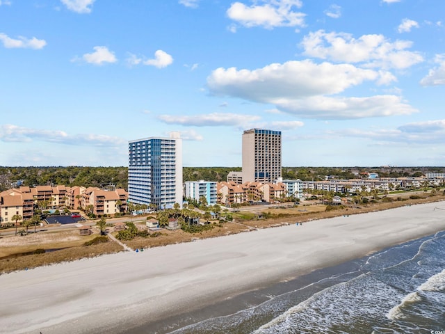 bird's eye view featuring a city view, a water view, and a beach view