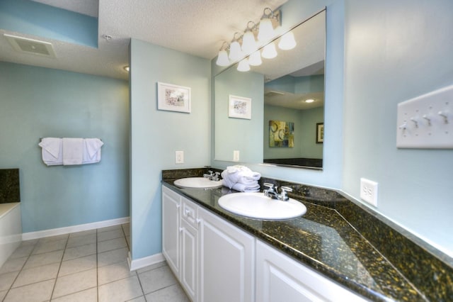 bathroom with vanity, tile patterned flooring, and a textured ceiling