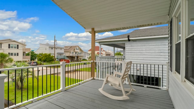 wooden terrace featuring a lawn