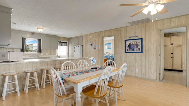 dining room featuring ceiling fan and light hardwood / wood-style flooring