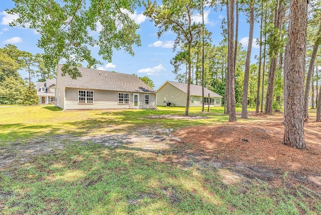 rear view of property featuring a yard