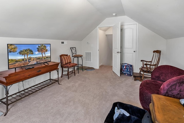 living area featuring lofted ceiling and light colored carpet