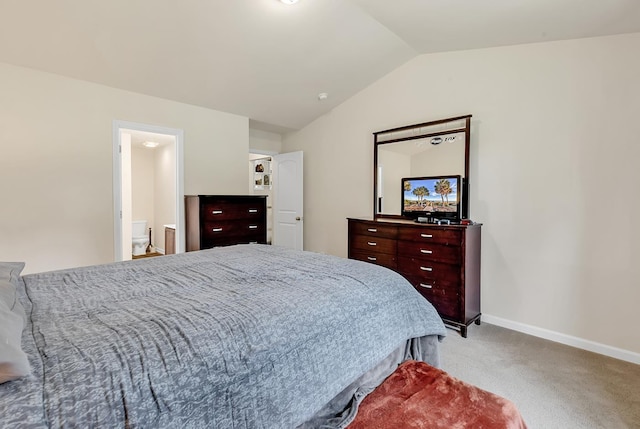 bedroom featuring lofted ceiling, ensuite bathroom, and carpet