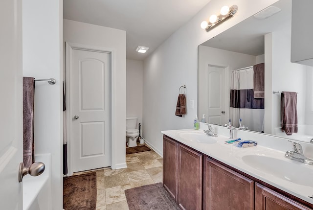 bathroom with vanity and toilet