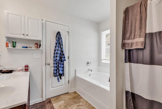 bathroom featuring vanity and a bathing tub