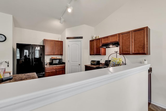 kitchen featuring lofted ceiling, track lighting, and black appliances