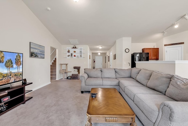 living room with rail lighting and light carpet