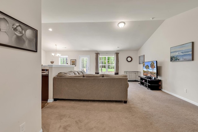 living room featuring vaulted ceiling, light colored carpet, and a chandelier