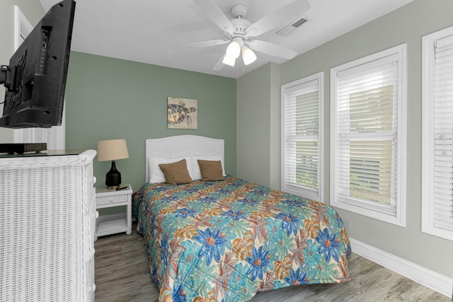 bedroom featuring hardwood / wood-style flooring and ceiling fan