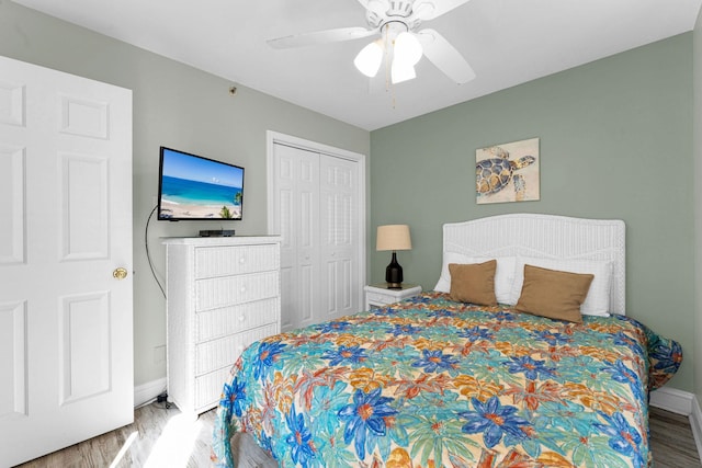 bedroom featuring hardwood / wood-style flooring, a closet, and ceiling fan