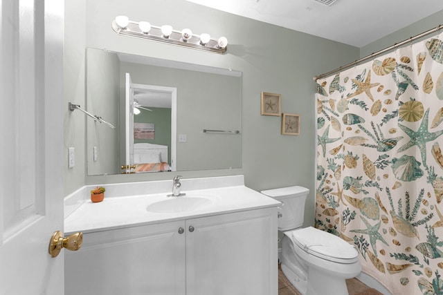 bathroom with vanity, toilet, tile patterned flooring, and ceiling fan