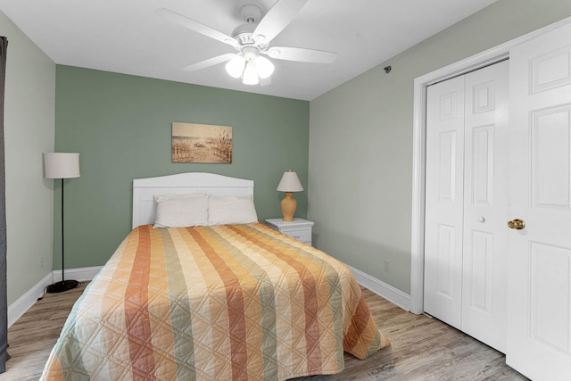 bedroom with ceiling fan, hardwood / wood-style flooring, and a closet