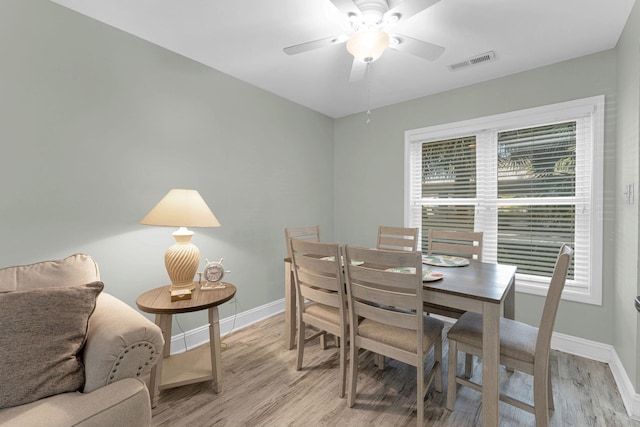 dining room featuring light hardwood / wood-style floors and ceiling fan