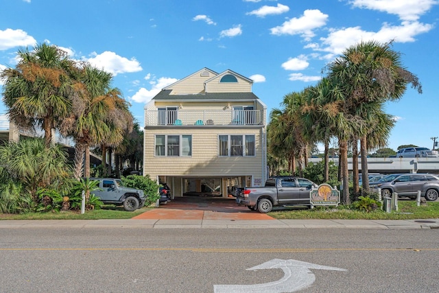 4314 S Ocean Blvd Unit B-1, North Myrtle Beach, SC 29582 - coastal inspired home with a balcony, a carport, and concrete driveway