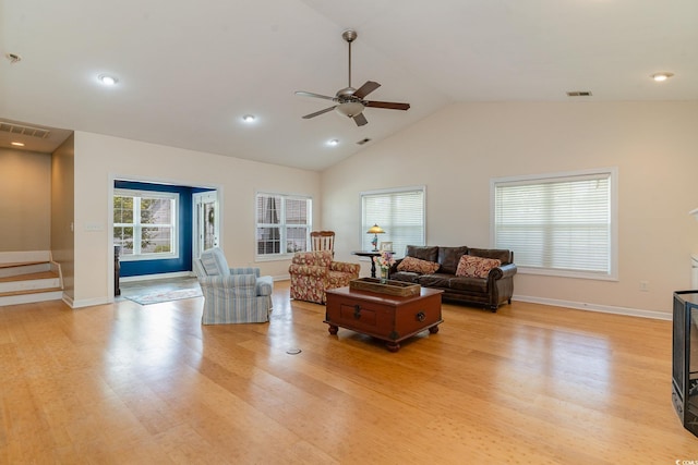 living room featuring ceiling fan, lofted ceiling, and light hardwood / wood-style flooring