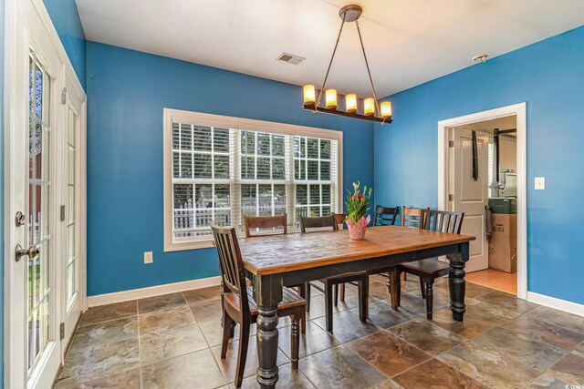 dining space featuring an inviting chandelier