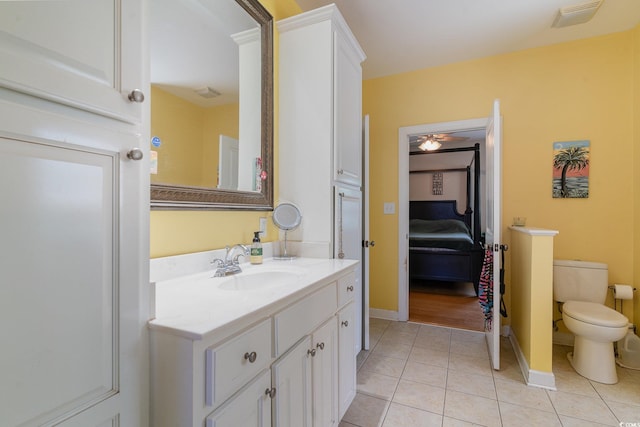 bathroom featuring vanity, toilet, and tile patterned flooring