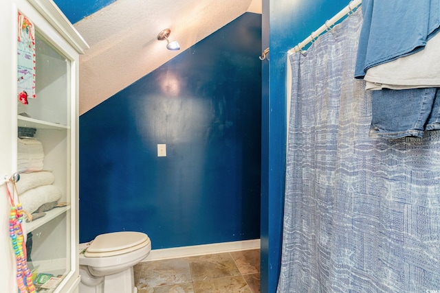 bathroom with a textured ceiling and toilet