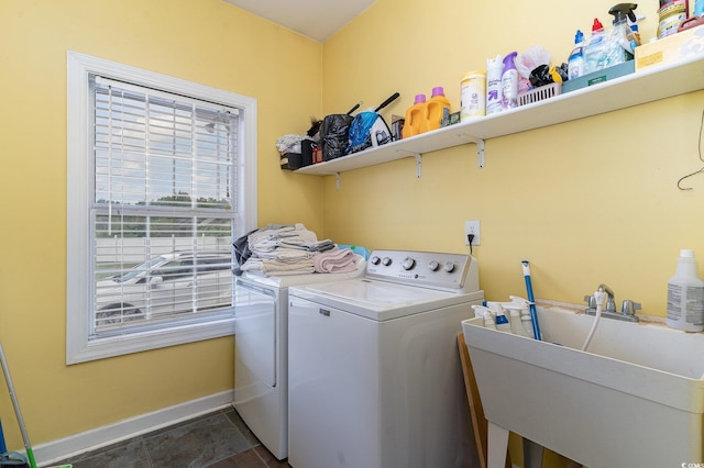 laundry area with washer and clothes dryer and sink