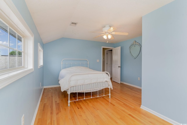 bedroom featuring lofted ceiling, ceiling fan, and light hardwood / wood-style flooring