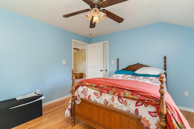 bedroom with ceiling fan, lofted ceiling, and light hardwood / wood-style floors